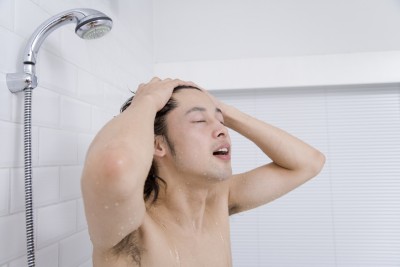 Man shampooing his head in shower
