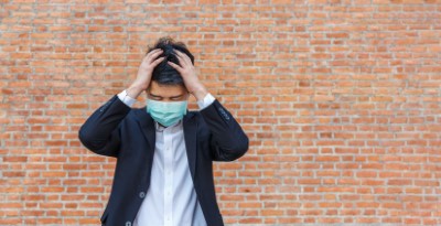 Business man in distress of job losses due to COVID-19 virus pandemic