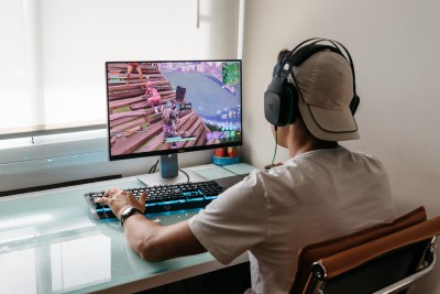Teenager playing Fortnite video game on PC
