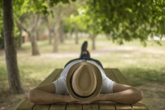 Restful,Young,Man,Wearing,A,Straw,Hat,Laying,Down,On