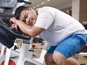 An,Overweight,Young,Man,Exhausted,With,Exercising,In,Fitness,Center.